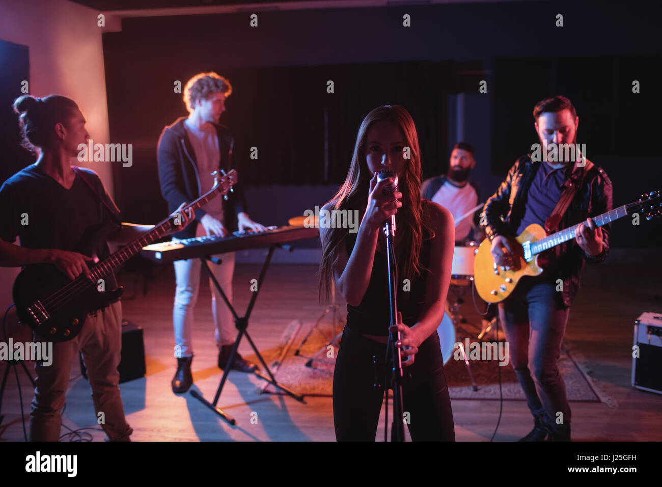 Band performing in recording studio Stock Photo Alamy