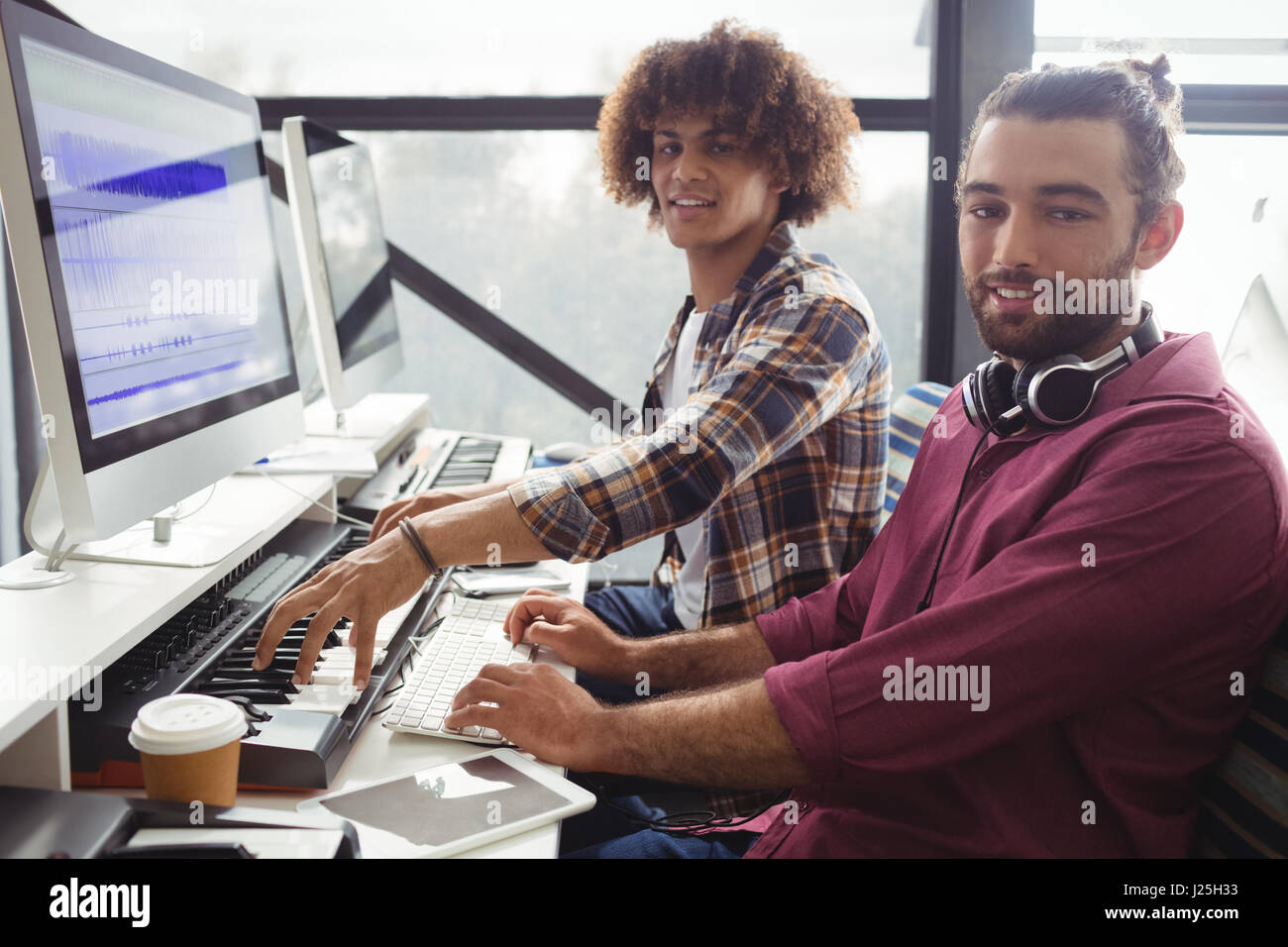 Portrait of two sound engineers working together in studio Stock Photo ...