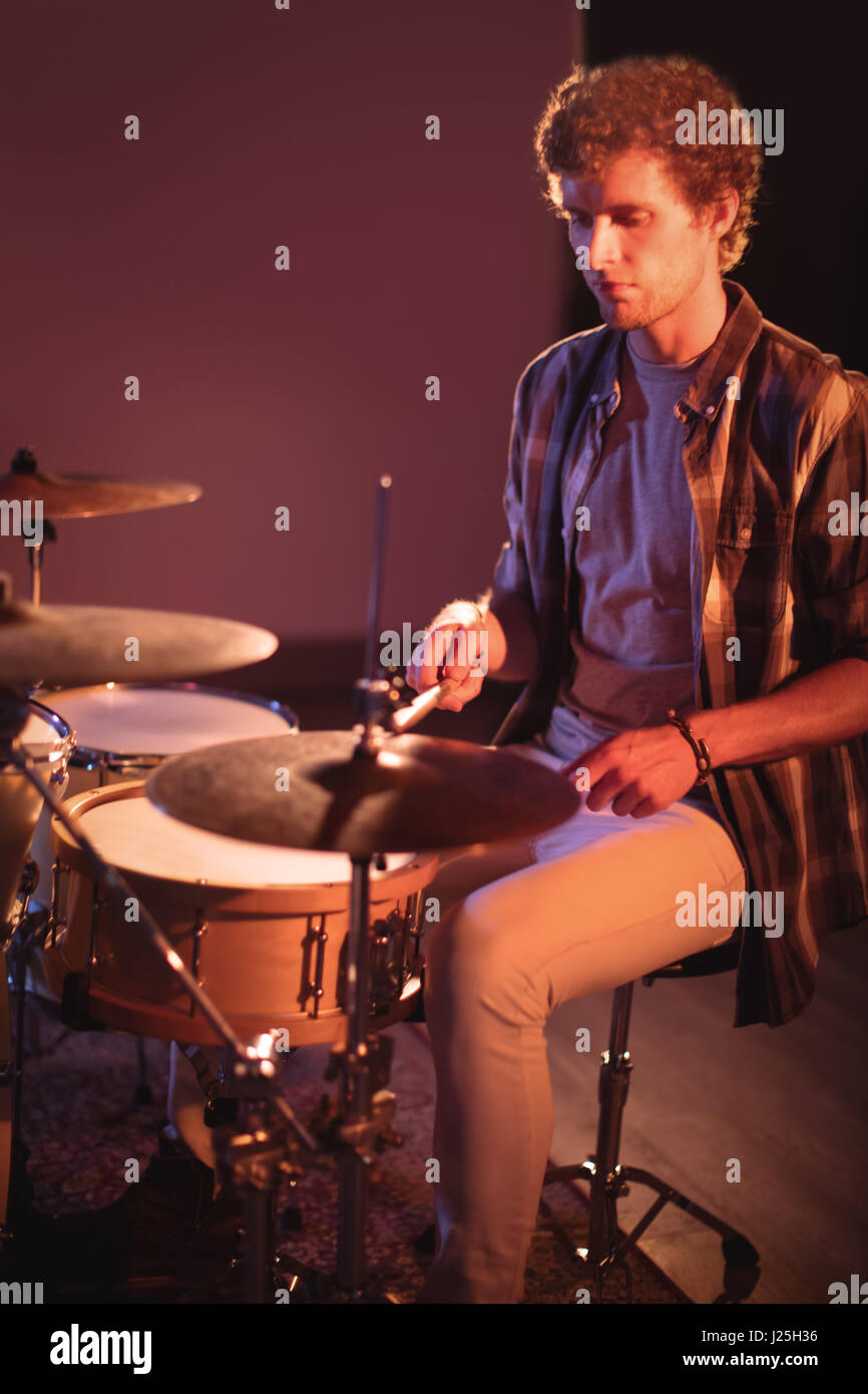 Drummer playing on drum set in recording studio Stock Photo - Alamy