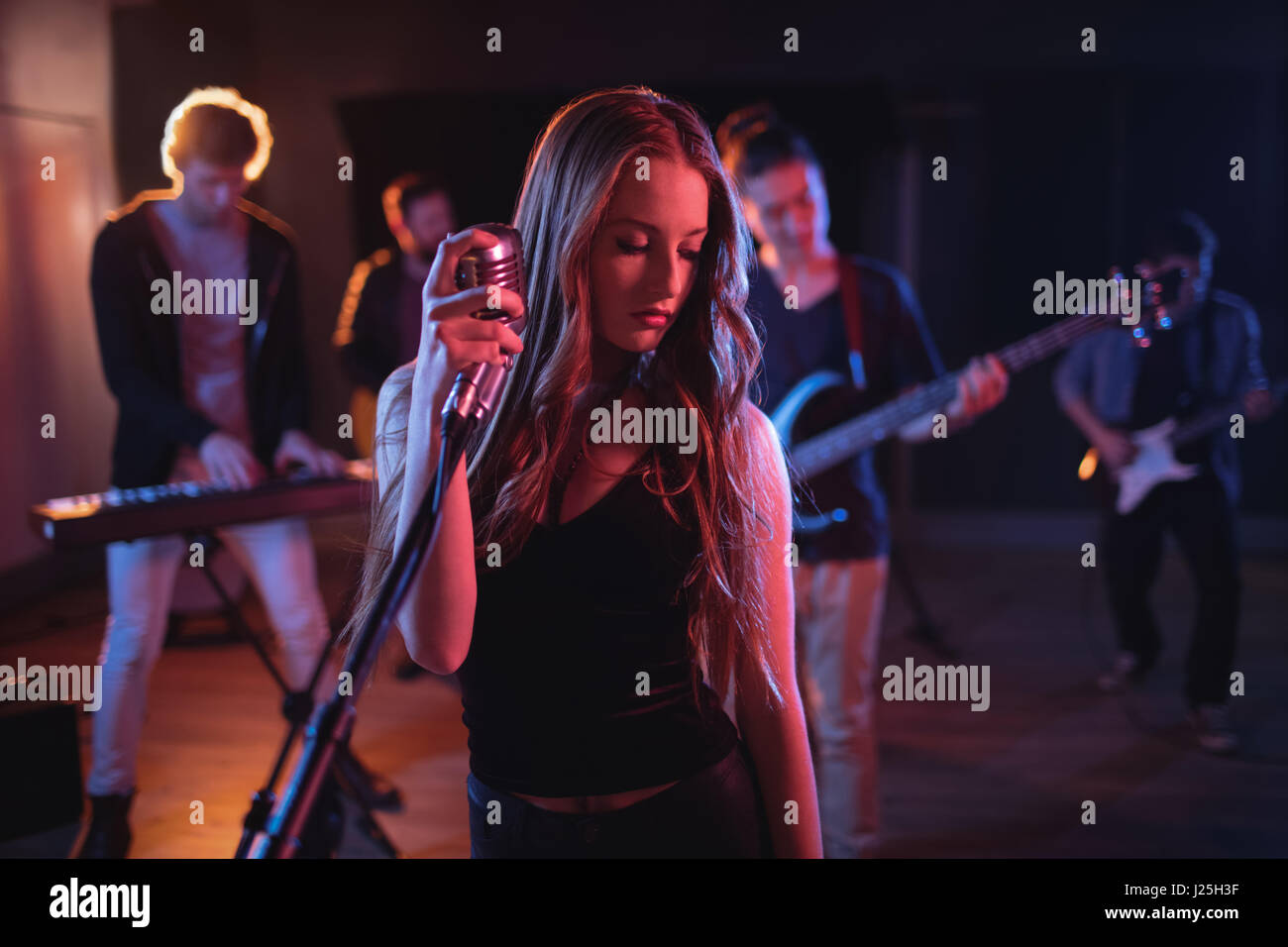 Band performing in recording studio Stock Photo Alamy