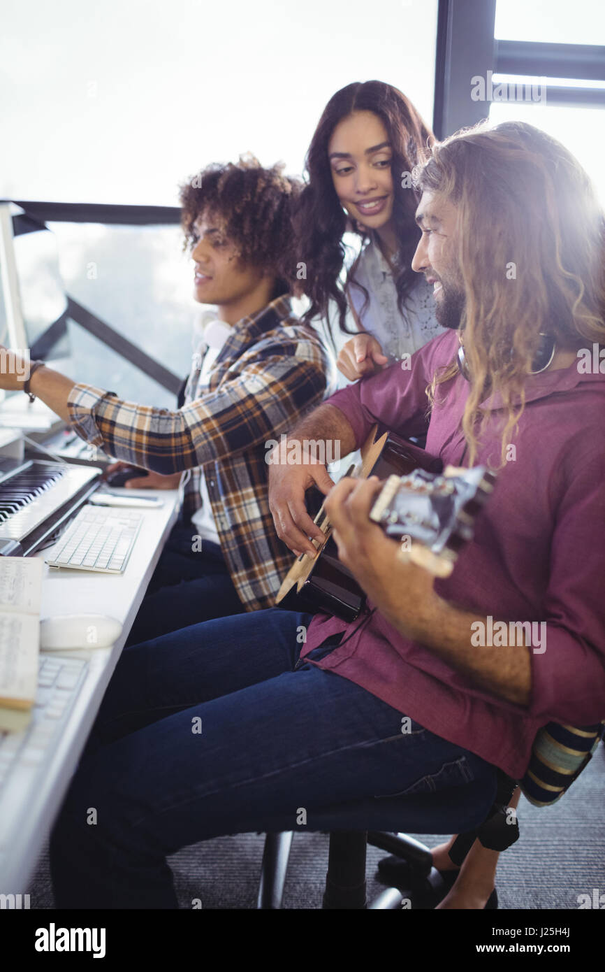 Three sound engineers working together in the studio Stock Photo - Alamy