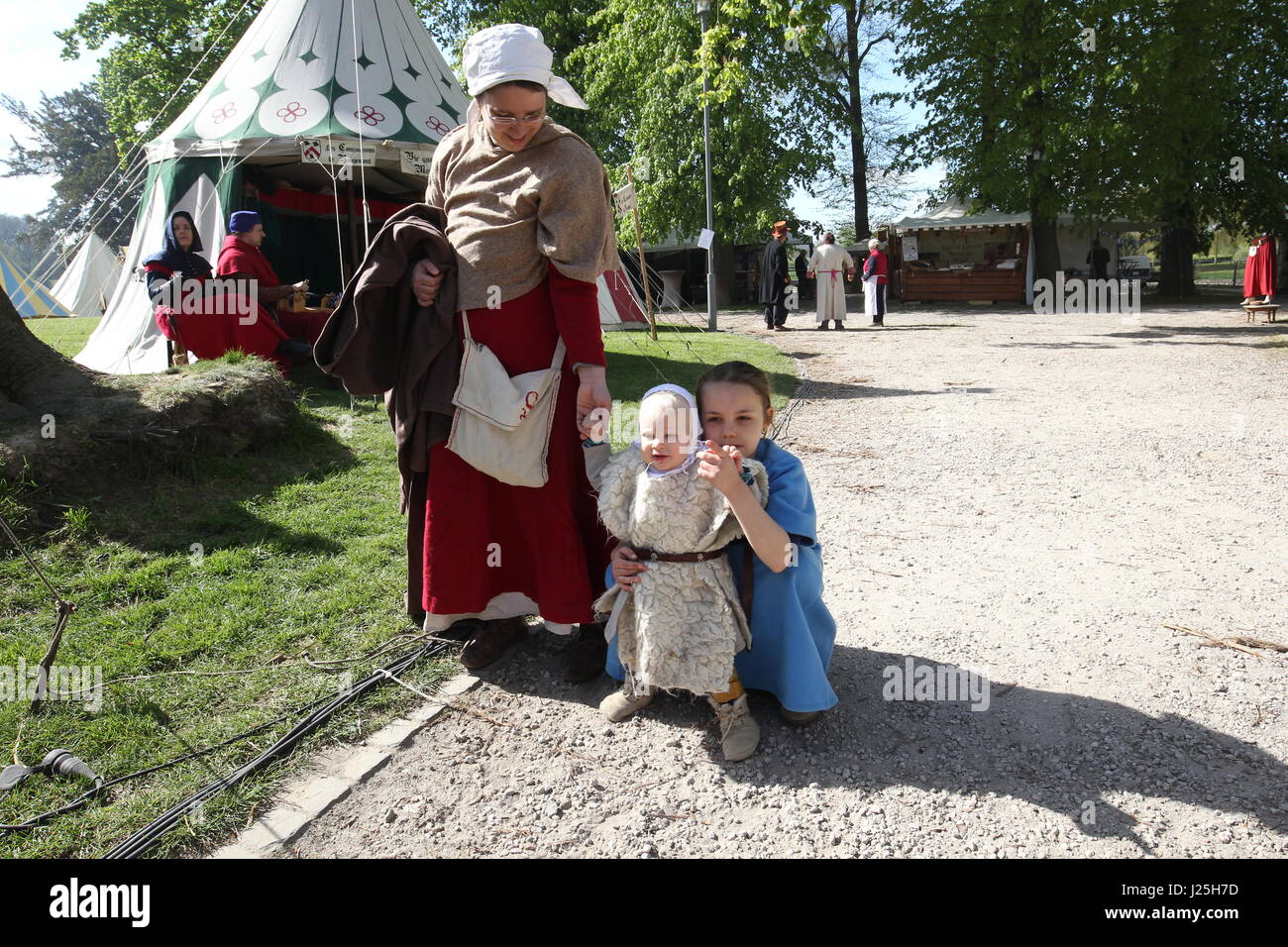 People in costume and items for sale at a medieval fair Stock Photo - Alamy