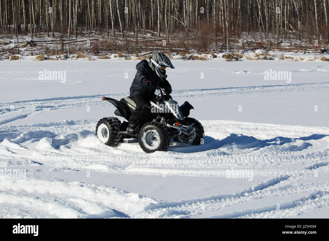 Child Driving a Quad in the Snow Stock Photo Alamy