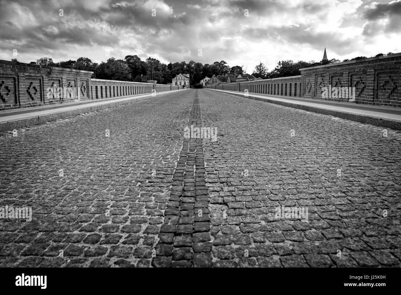 Old bridge over the river with pavement Stock Photo Alamy