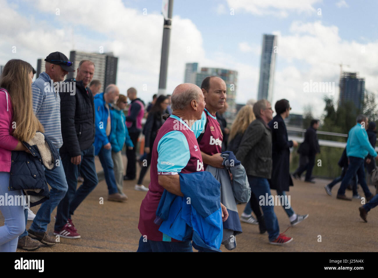 West Ham fans on their way to the match outside the London Stadium, in Stratford, east London. Stock Photo