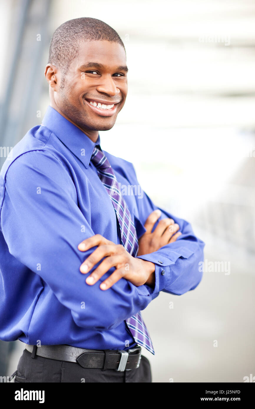 A portrait of a smiling black businessman outdoor Stock Photo - Alamy