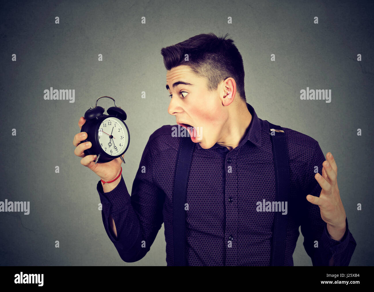 Staring At Clock Rage Anxious young man looking at alarm clock. Time pressure concept. Human ...