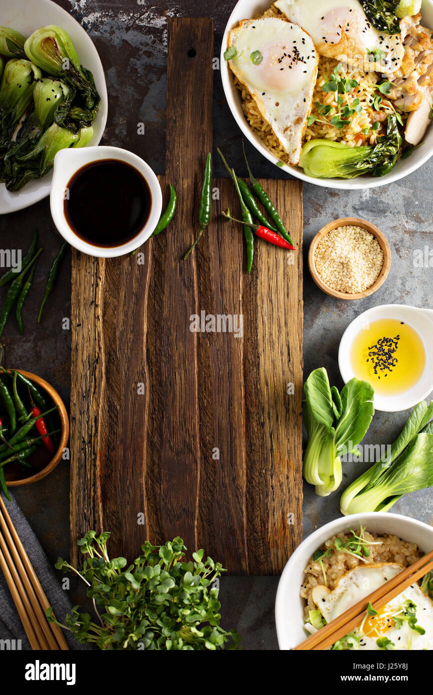Asian food concept with fried rice, baby bok choy, eggs and soy sauce with copyspace Stock Photo