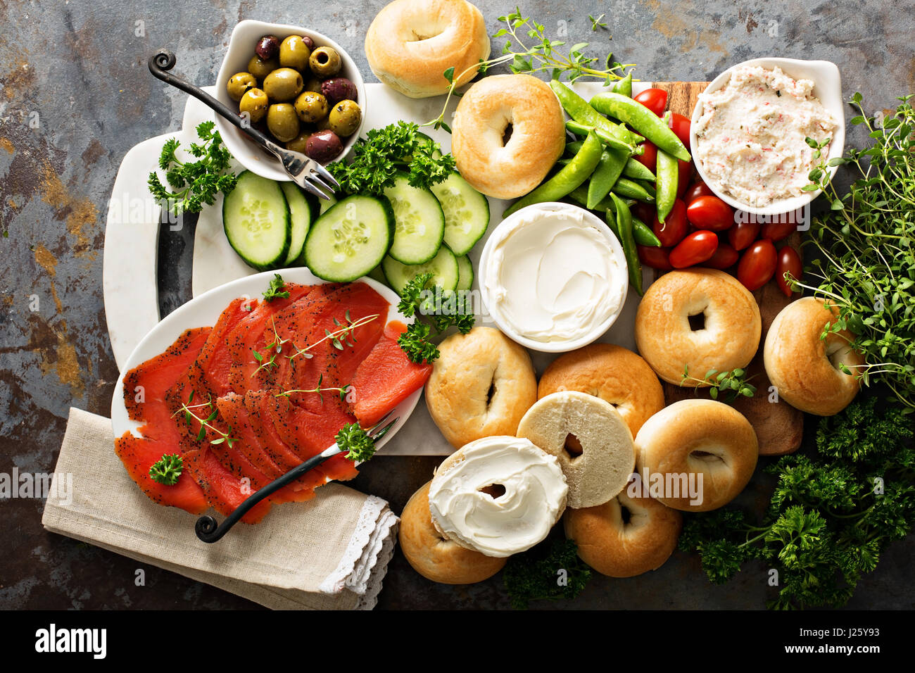 Big breakfast platter with cream cheese, bagels, smoked salmon and vegetables Stock Photo