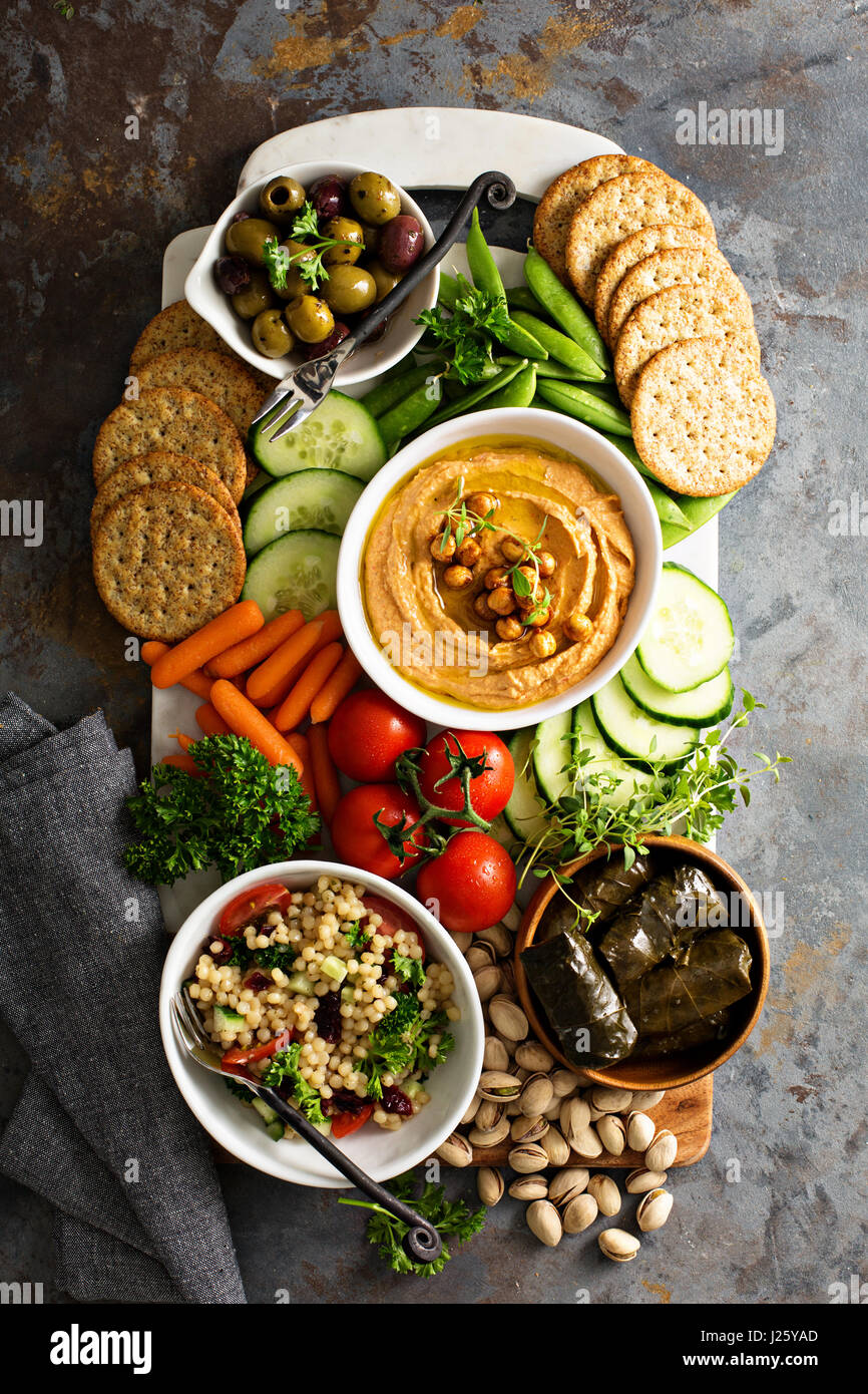 Hummus with vegetables and pita bread platter bread hires stock