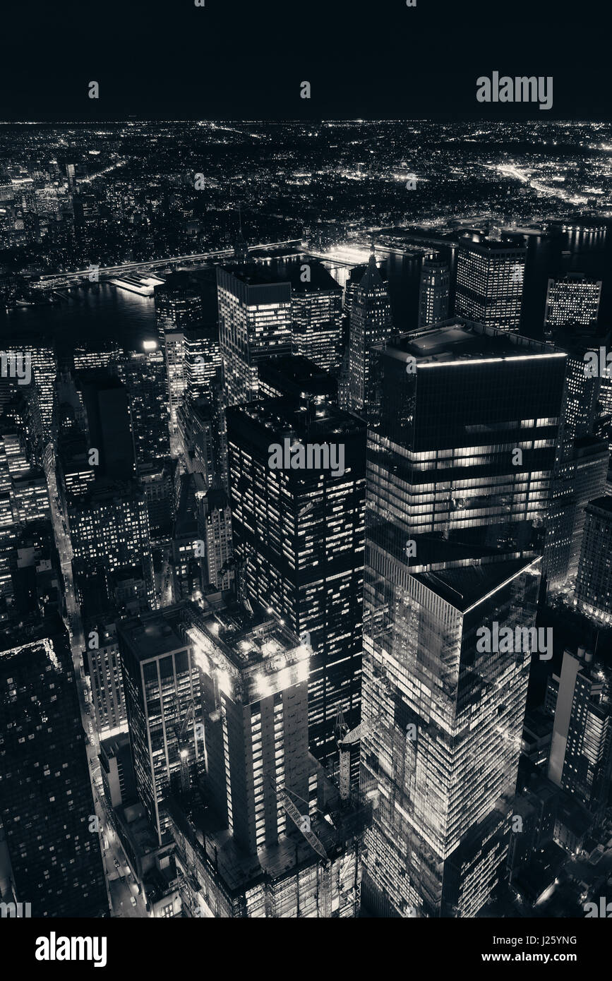 Rooftop night view of New York City downtown with urban skyscrapers ...