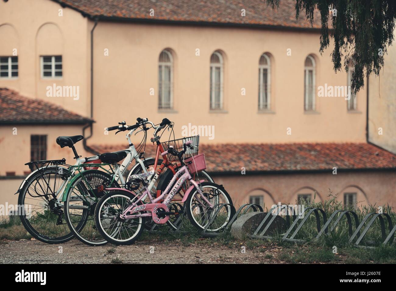 LUCCA - MAY 19: Bikes with old church on May 19, 2016 in Lucca, Italy. It is famous for its well preserved Renaissance-era city walls and the tourism Stock Photo