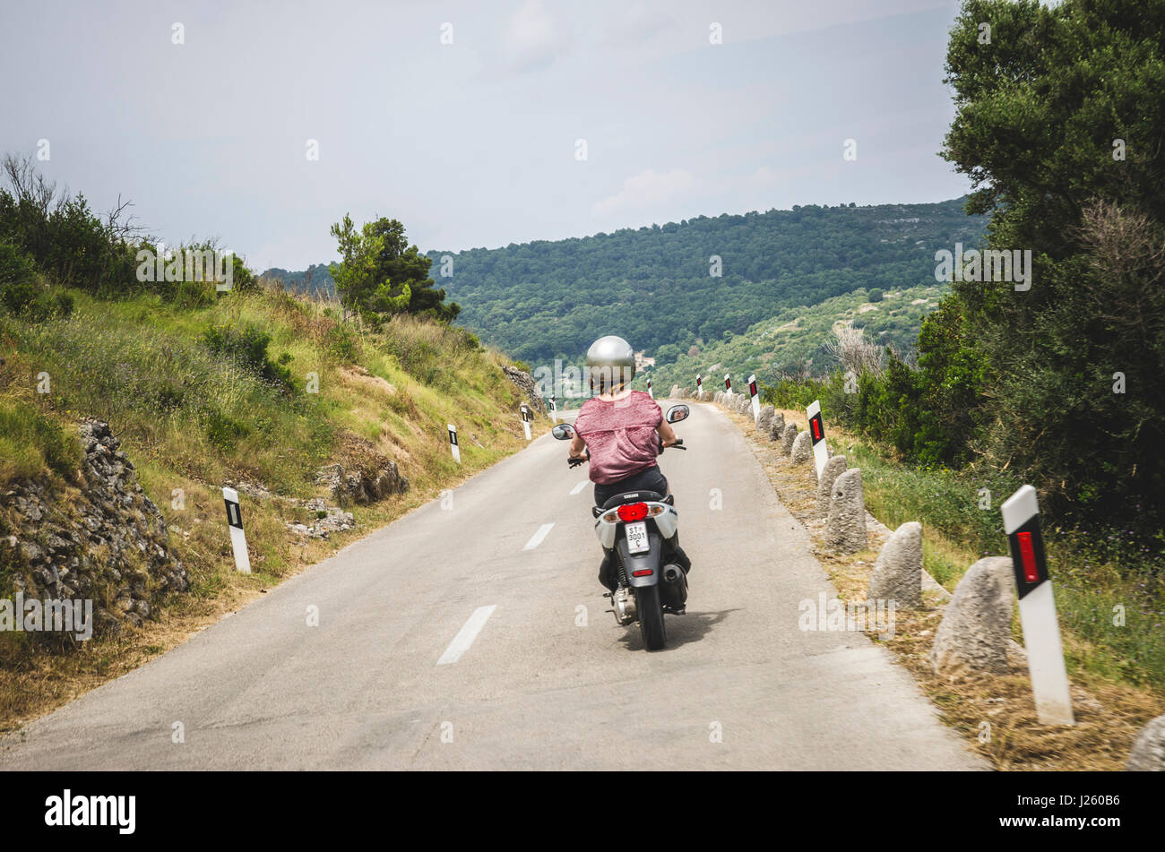 Young Woman Riding Motor Scooter Through Island of Vis, Croatia Stock Photo  - Alamy