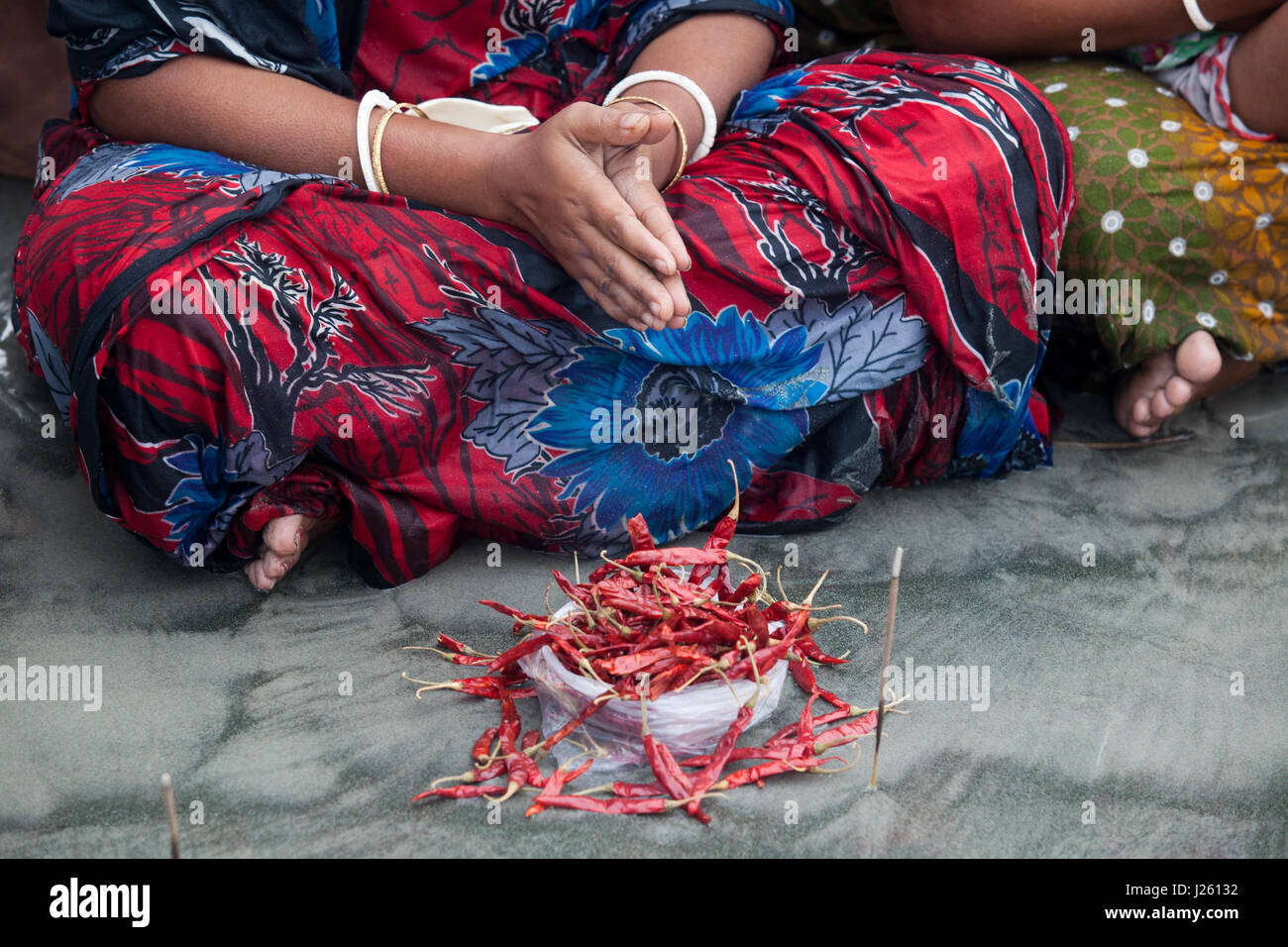 People from the Hindu community offer Morning Prayer at the shore of the Bay of Bengal during the Rash Mela at Dublarchar in the Eastern Division of S Stock Photo