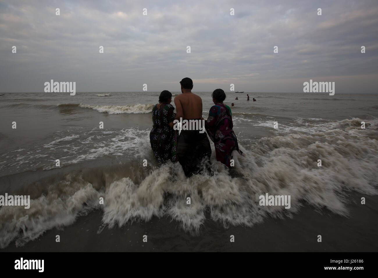 People from the Hindu community bathe at the Bay of Bengal during the Rash Mela at Dublarchar in the Eastern Division of Sundarbans forest. Bagerhat,  Stock Photo