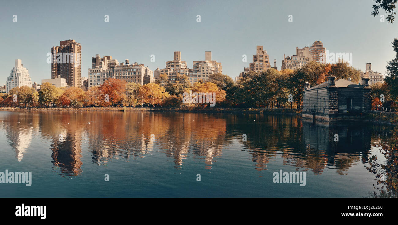 Central park Manhattan east side luxury building panorama over lake in Autumn in New York City. Stock Photo
