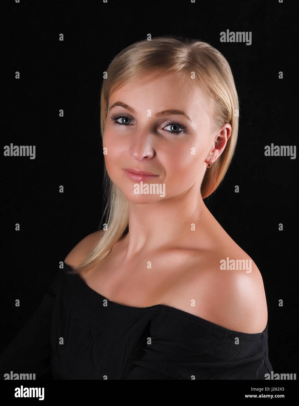 Beautiful girl in a black dress on a gray background Stock Photo - Alamy