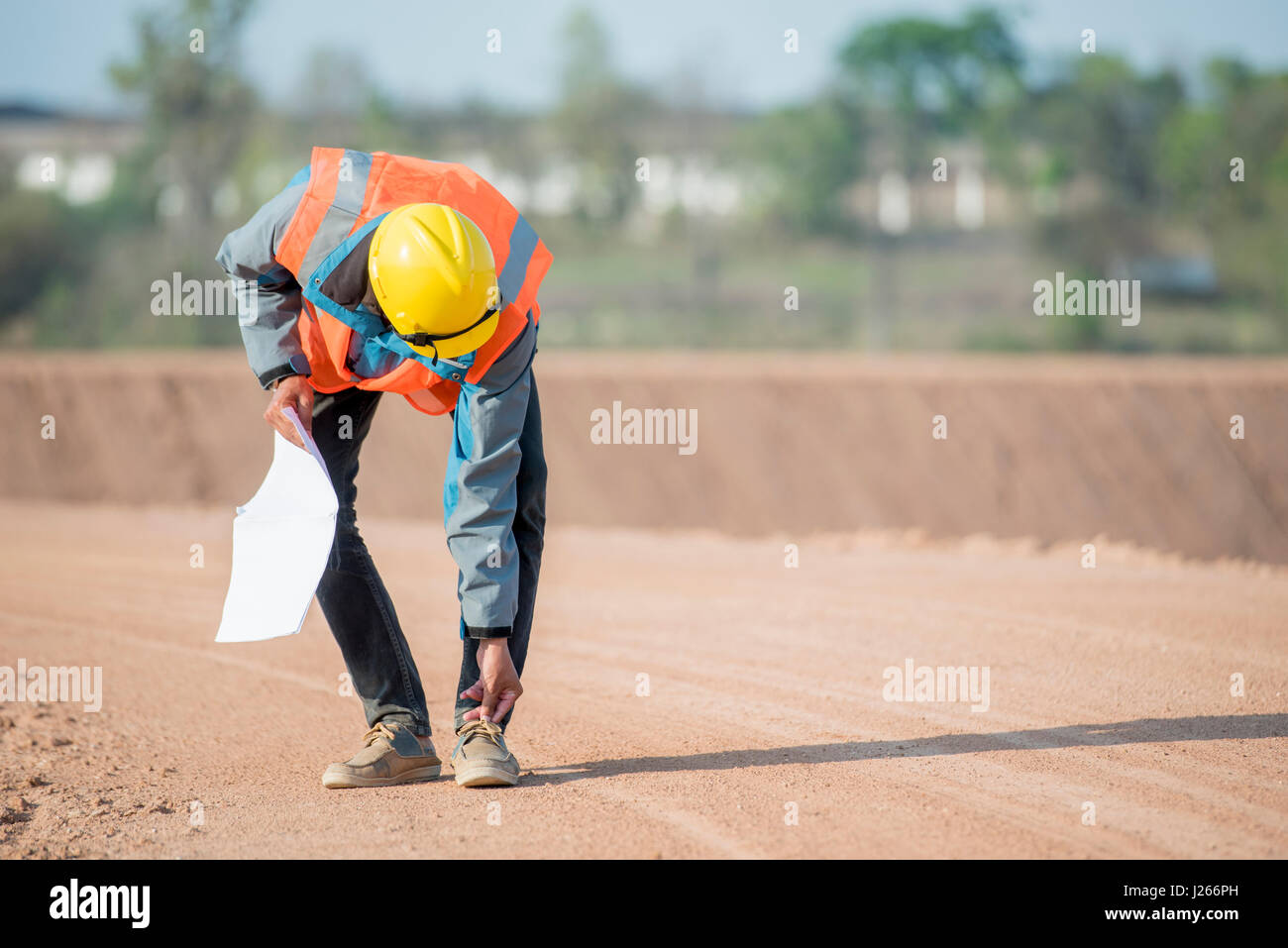 Civil engineer in safety uniform shoe rack in construction site Stock Photo