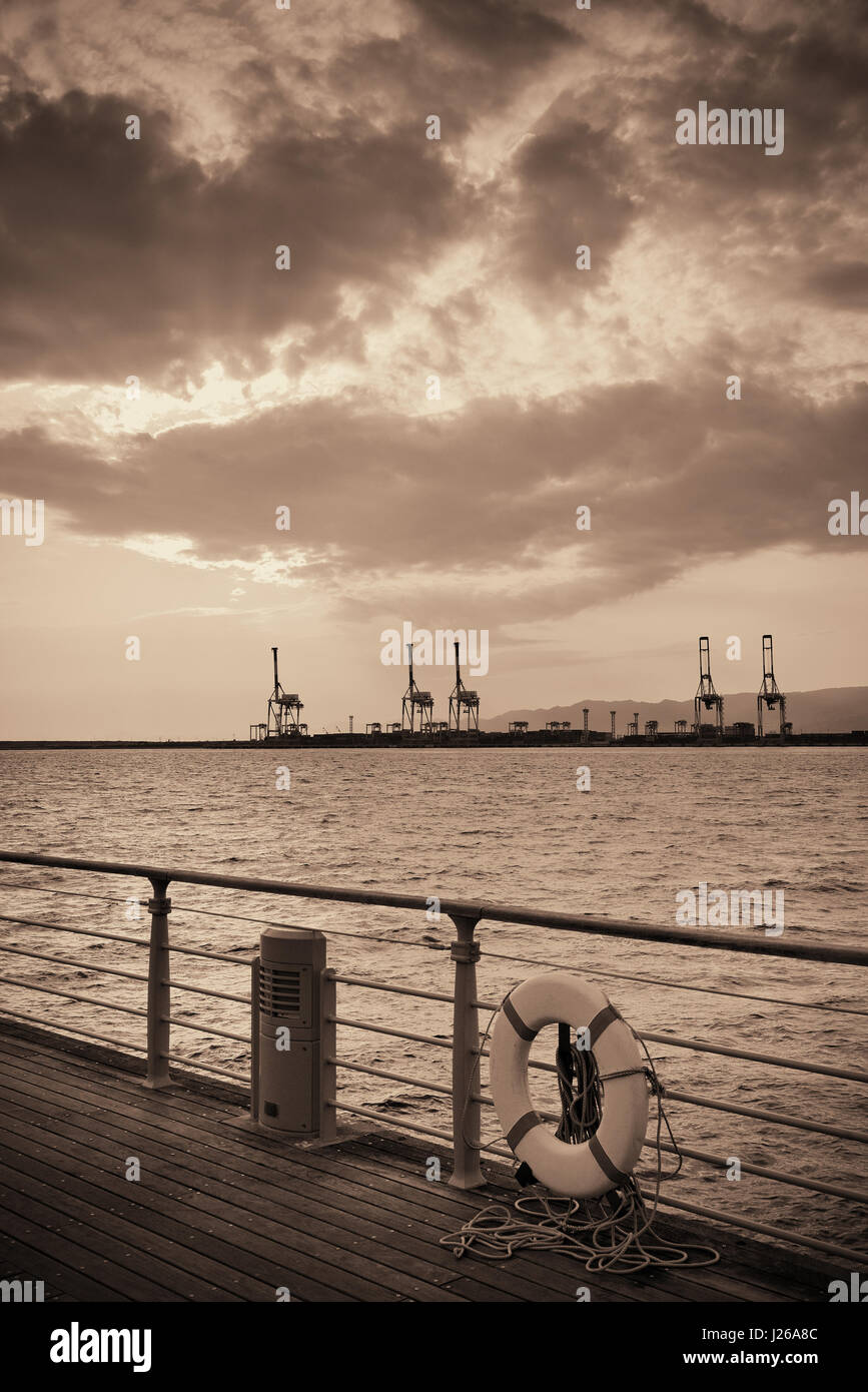 Osaka seaport with crane silhouette at sunset. Japan Stock Photo Alamy