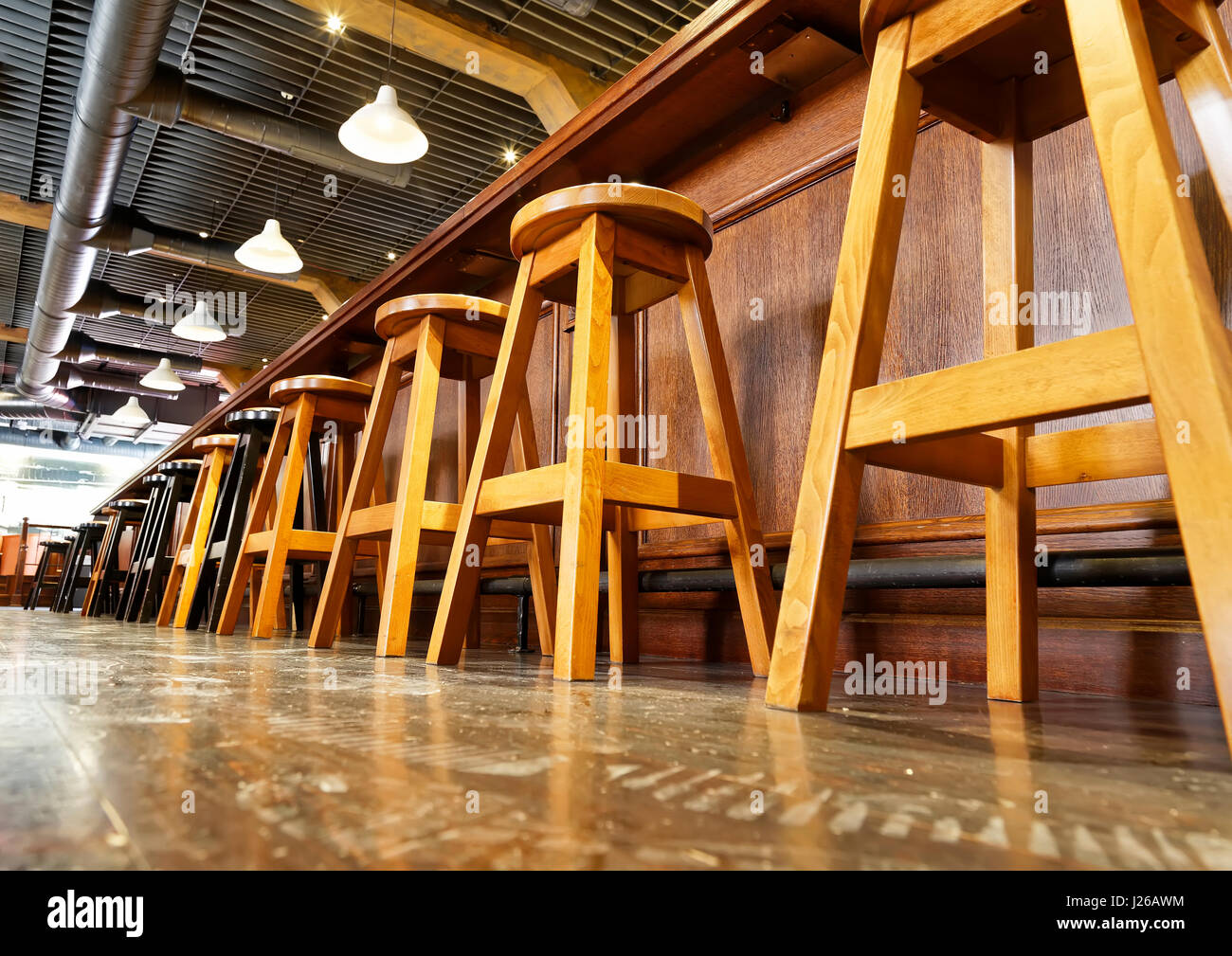 wooden bar stools in a row Stock Photo