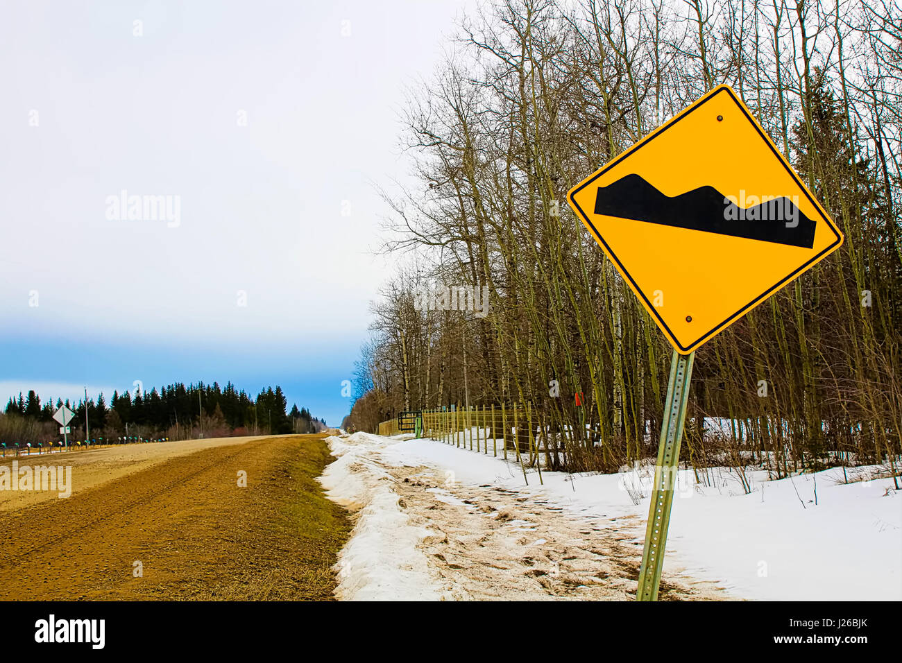 Warning rough road ahead sign. Stock Photo
