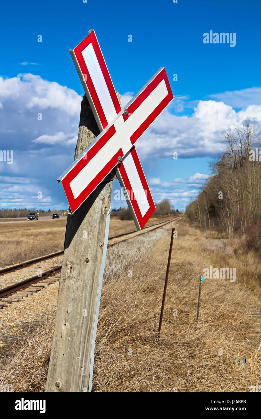 Railroad crossing sign along gravel road. Stock Photo