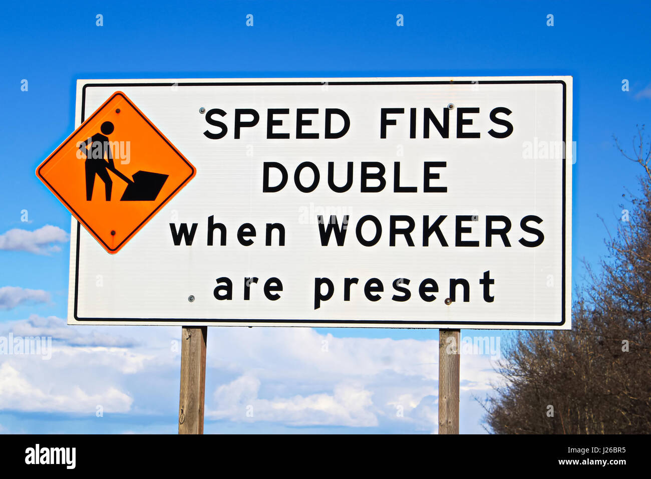 Speed fines double sign along highway. Stock Photo