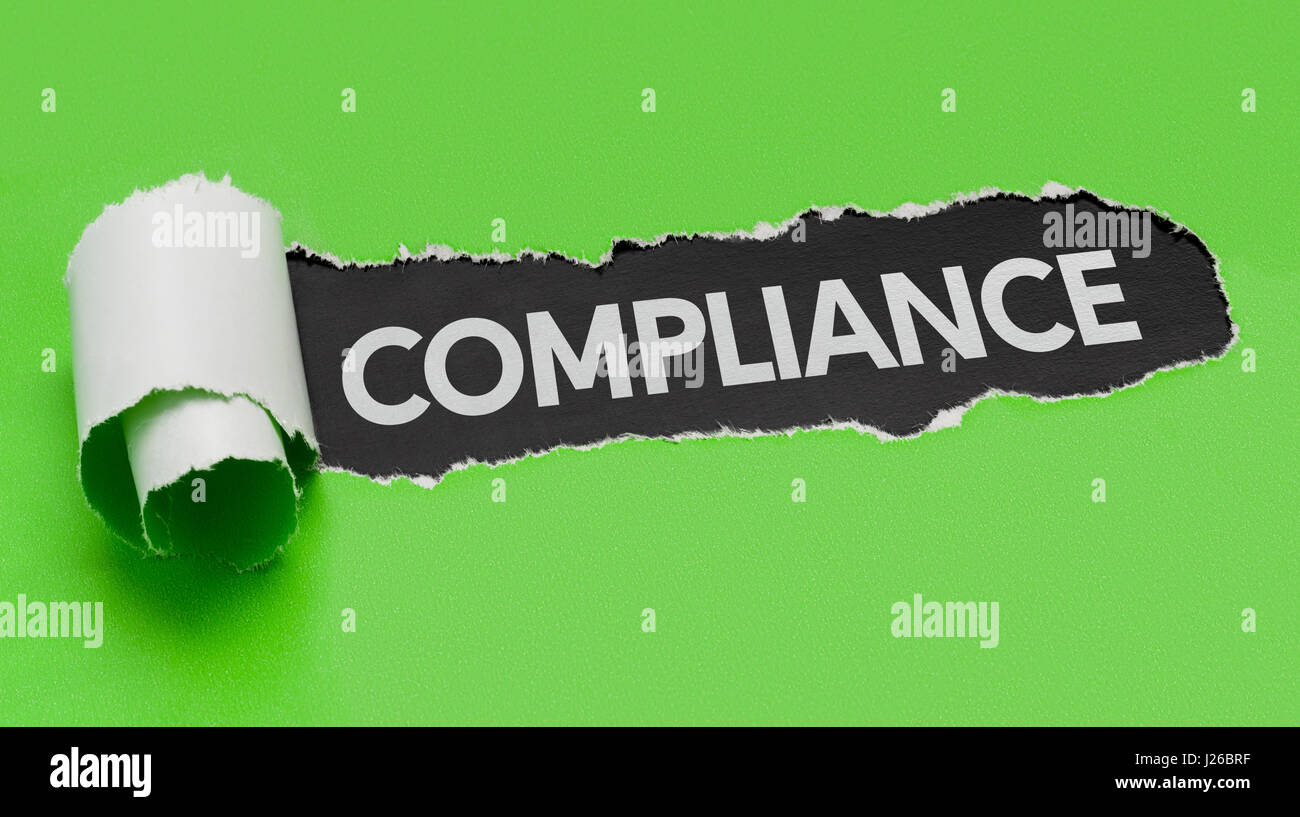 Torn green paper revealing the word Compliance Stock Photo - Alamy