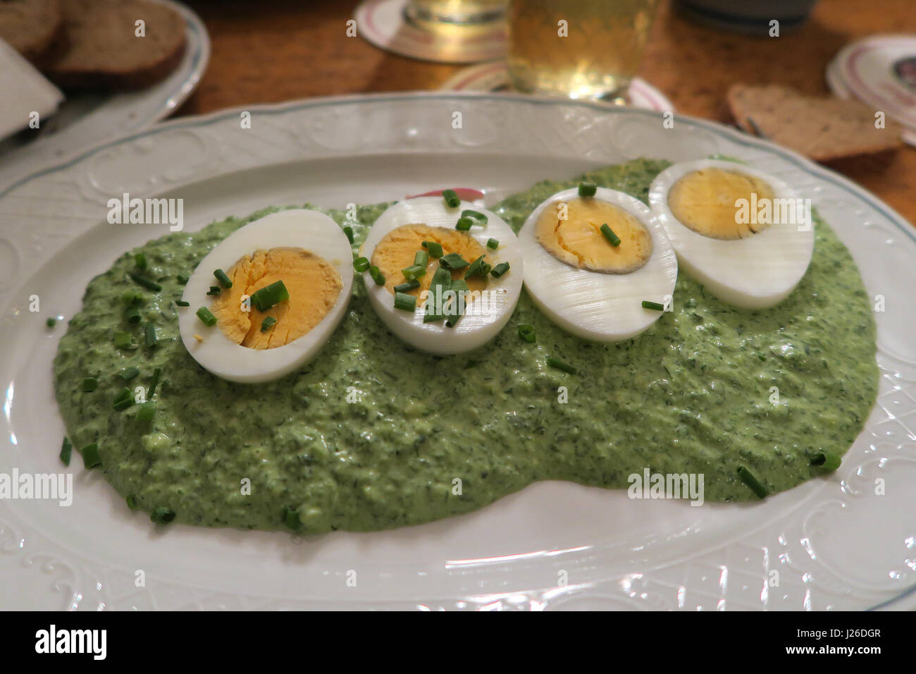 Sliced hard boiled eggs over spinach spred Stock Photo