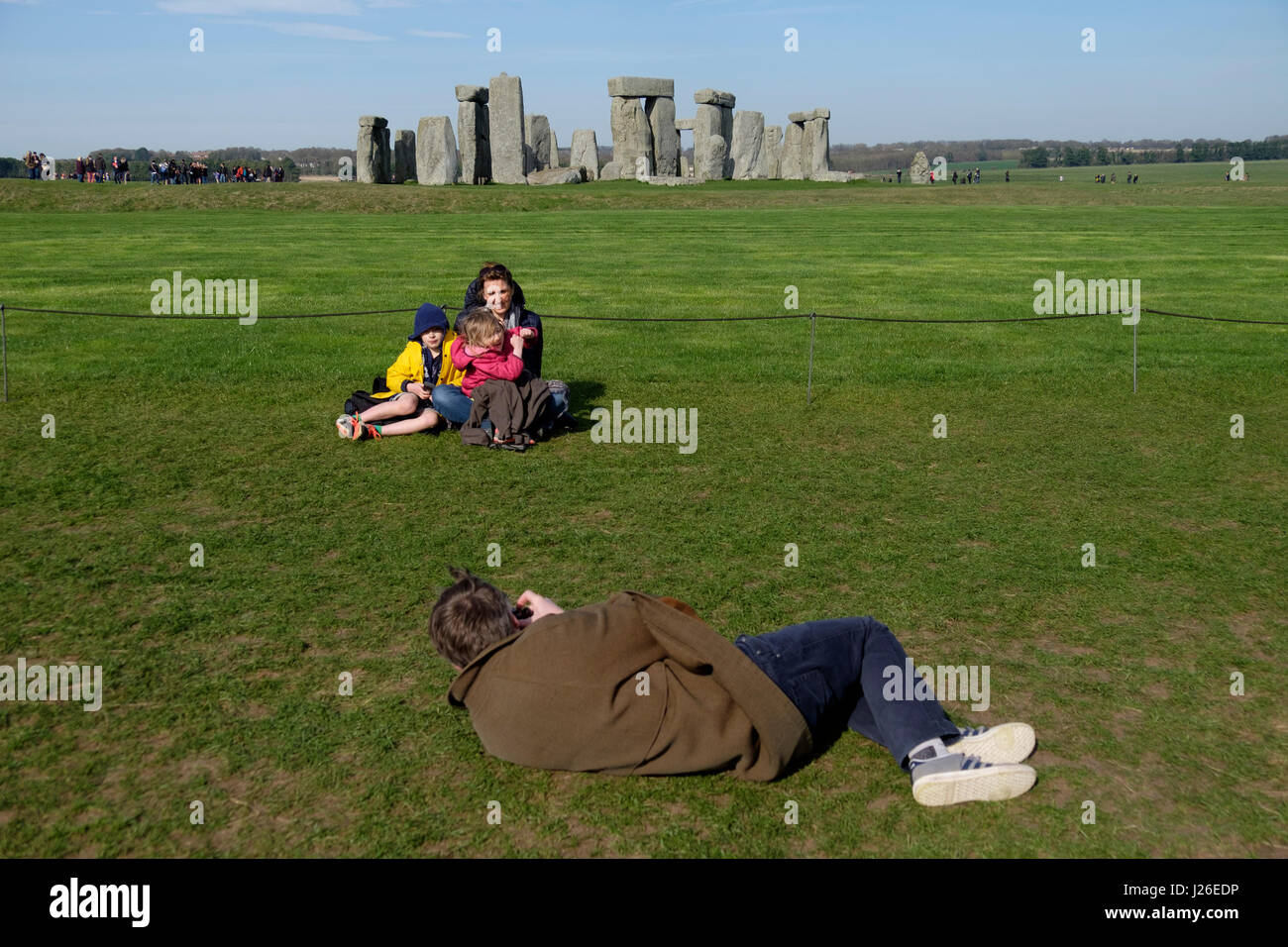 Family taking pictures in front of the Stonehenge prehistoric monument in Wiltshire, England Stock Photo