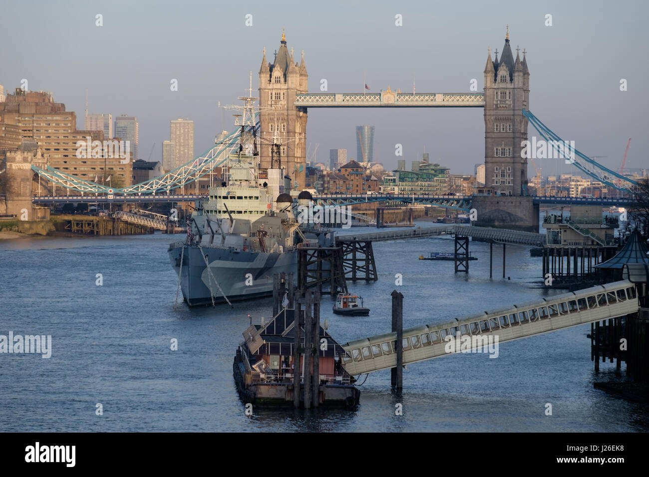 HMS Belfast warship moored on the River Thames next to the Tower Bridges, London, England, UK Stock Photo