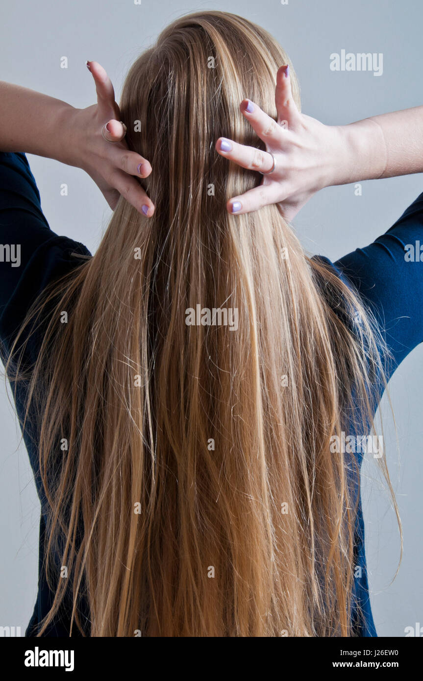 blond girl touching hair Stock Photo Alamy