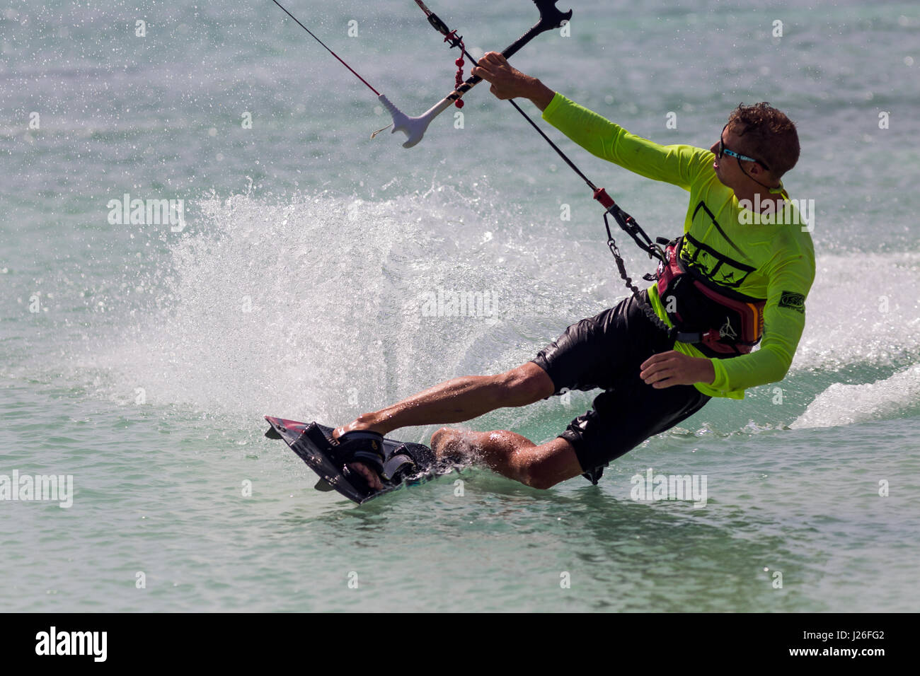 A parasailor carving some waves at Hadicurari Beach, Aruba Stock Photo