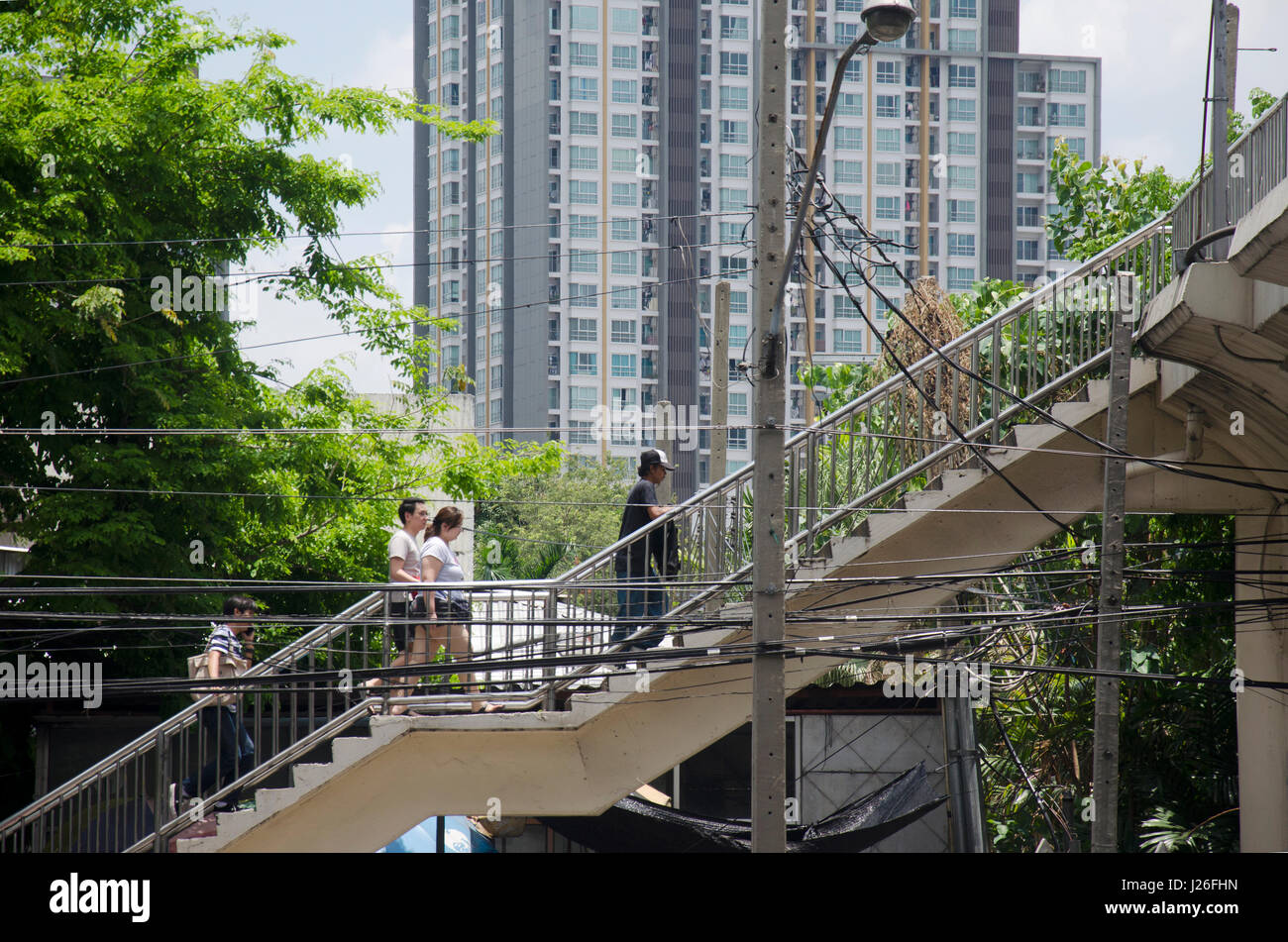 Asian thai people and foreigner traveler walking on bridge overpass ...