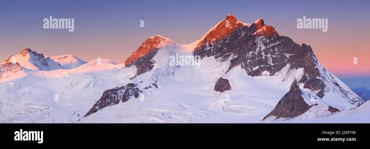 Sunrise over the Jungfrau peak from Jungfraujoch in Switzerland on a clear morning. Stock Photo