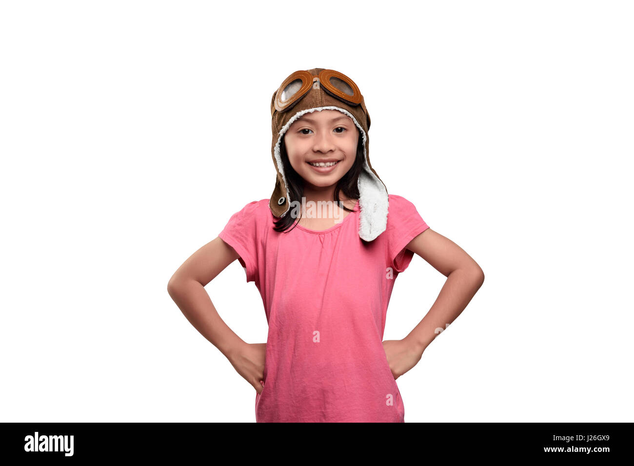 Smiling asian child in aviator helmet standing isolated over white background Stock Photo