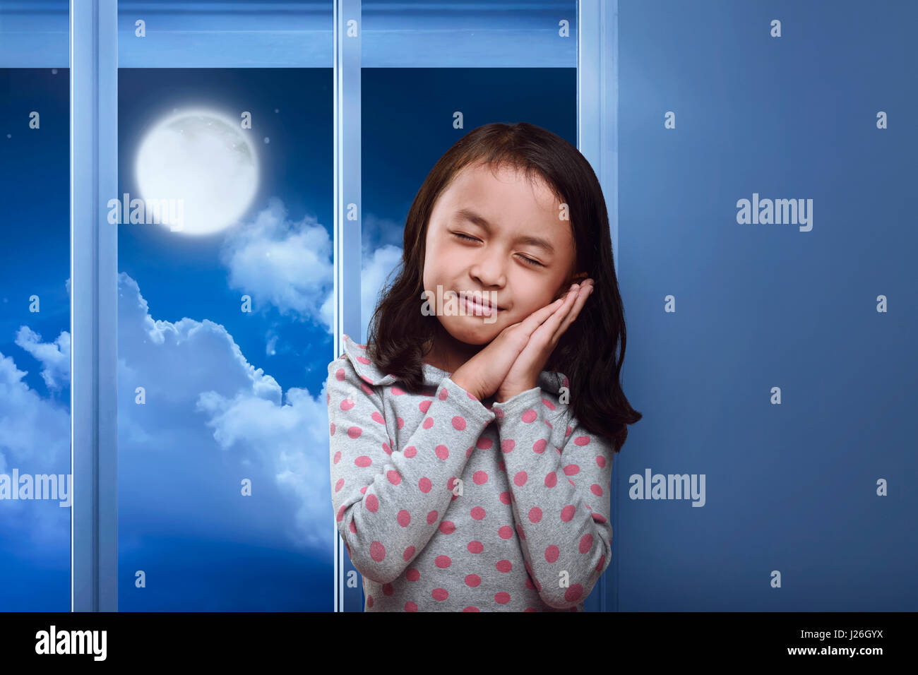Funny asian kid sleeping on her hand in the home at night Stock Photo