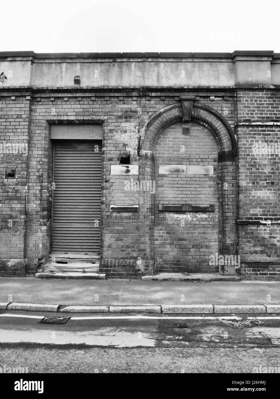 abandoned building  with shutter and bricked up doorway Stock Photo