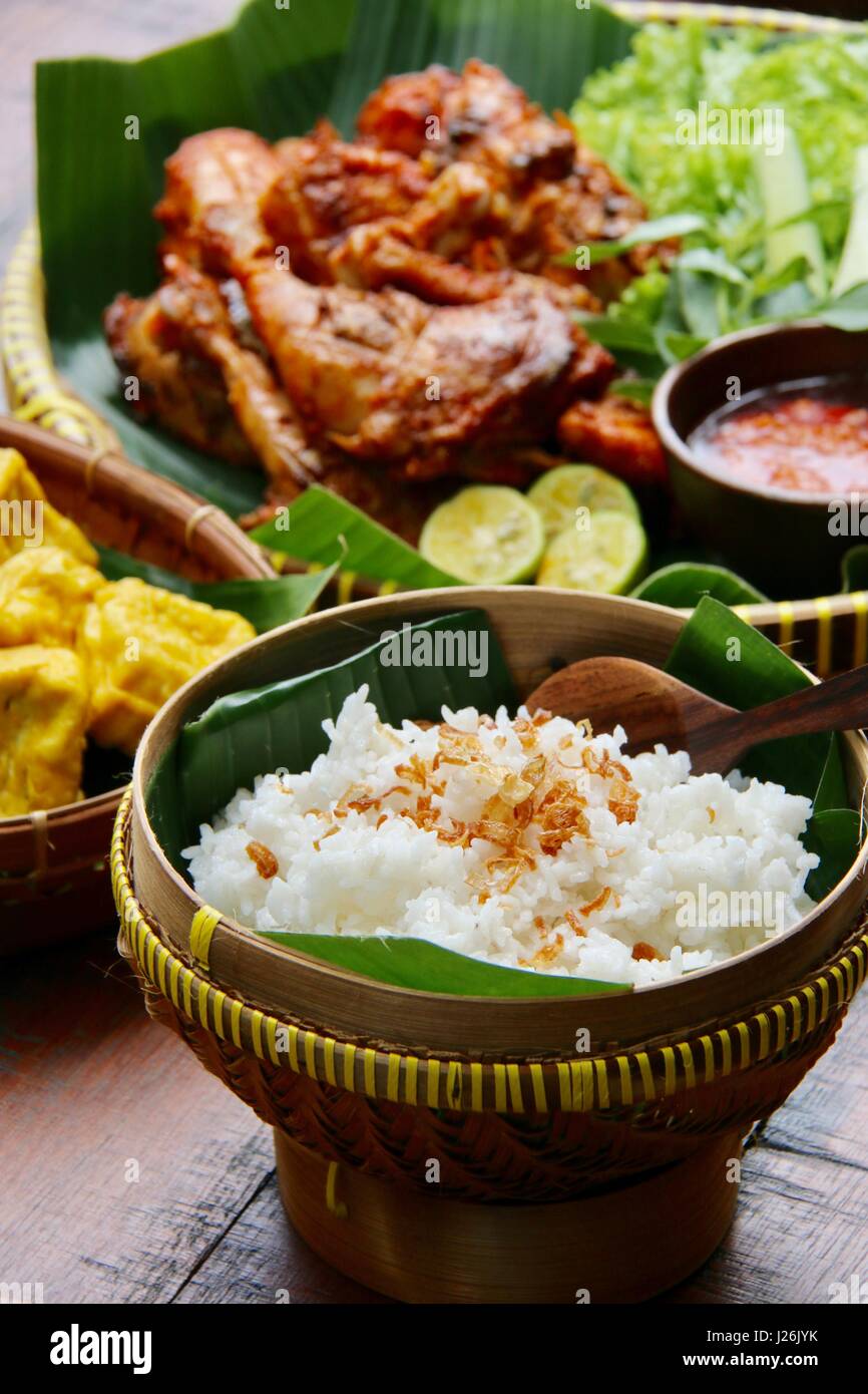 Steamed Rice in Traditional Bamboo Basket, Side Dish for Indonesian Char-grilled Chicken Stock Photo