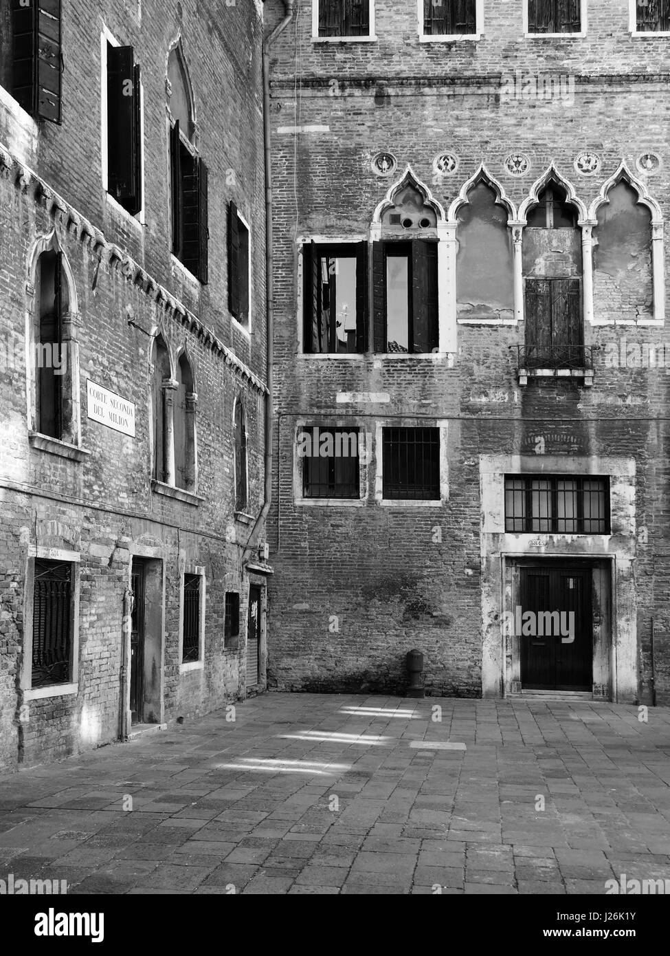 medieval courtyard in venice with old windows repaired walls and doors Stock Photo