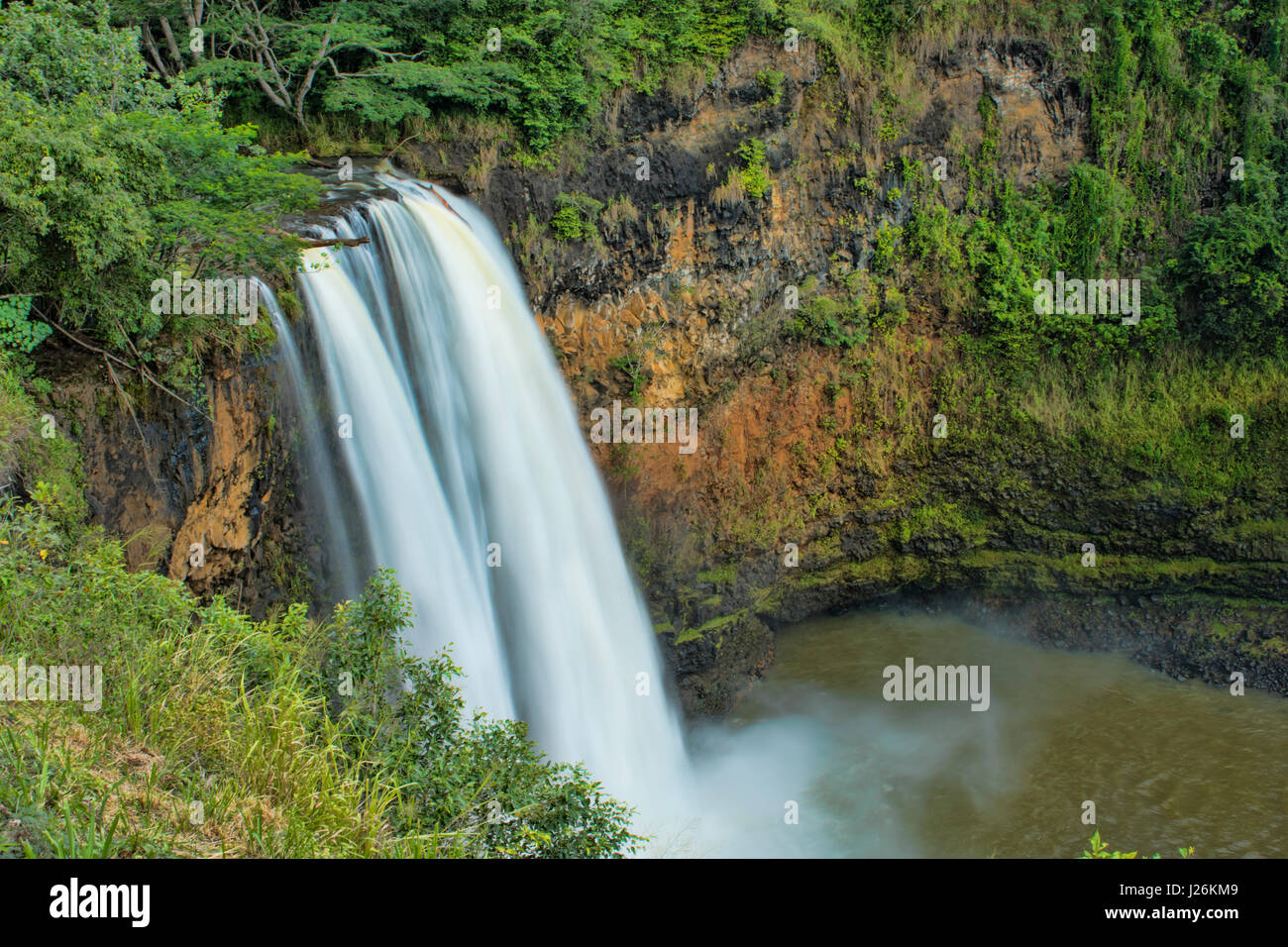 Kauai Hawaii Wailua Falls famous TV falls with water flow into lake tourist attraction Stock Photo