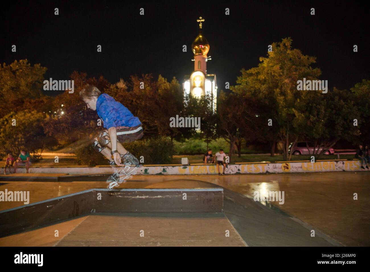 24.08.2016, Moldova, Transnistria, Tiraspol - Young skateboarder in the city center, the Georgskapelle in the background. Transnistria is a repulsive Moldovan republic under Russian influence east of the river Dnister. The region split from Moldova in 1992 and is not recognized by any other country. Even the Russian-dependent entity is known as the Transdnestrovian Moldavian Republic (Pridnestrovkaja Moldavskaja Respublika / PMR). Tiraspol is the capital. 00A160824D397CAROEX.JPG - NOT for SALE in G E R M A N Y, A U S T R I A, S W I T Z E R L A N D [MODEL RELEASE: NO, PROPERTY RELEASE: NO (c) c Stock Photo