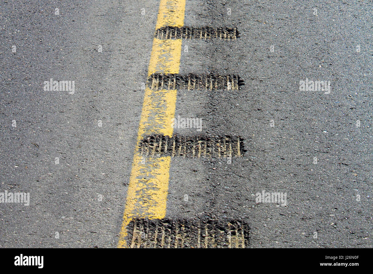 Closeup view of rumble strips on a road. Stock Photo