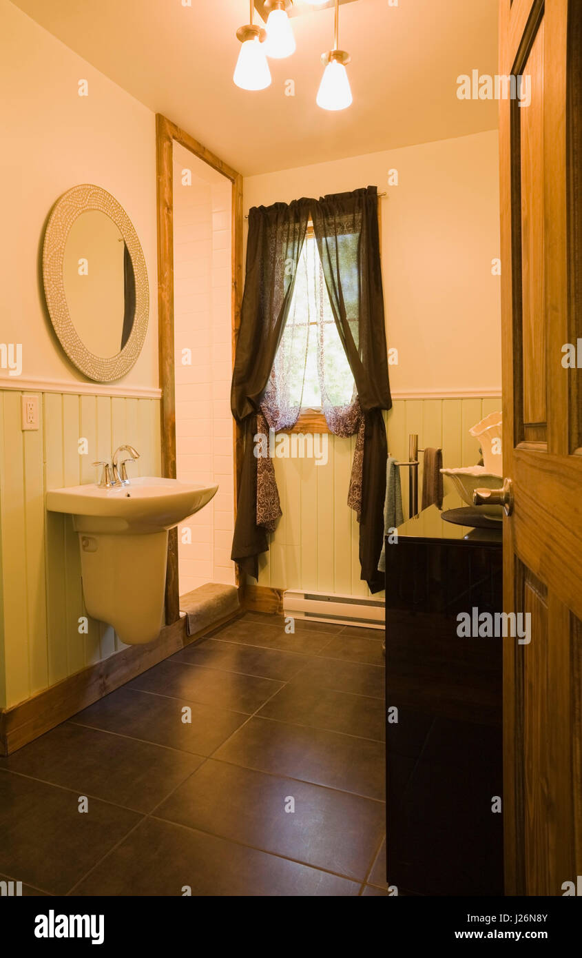 Upstairs bathroom inside a residential log home Stock Photo