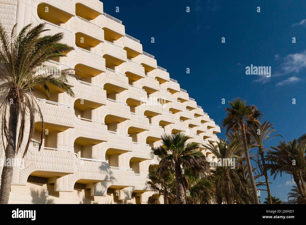 Hotel balconies and palm trees with deep blue sky in Fuerteventura, Spain Stock Photo