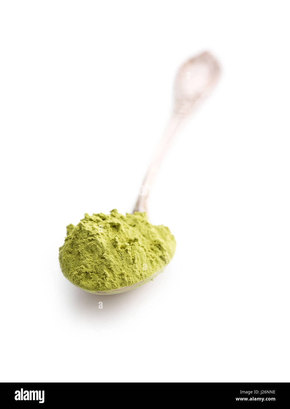 Green matcha tea powder in spoon isolated on white background. Stock Photo