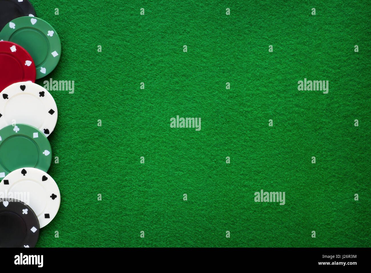 Poker chips on green felt casino table. Gambling, poker, blackjack and  roulette theme background Stock Photo - Alamy
