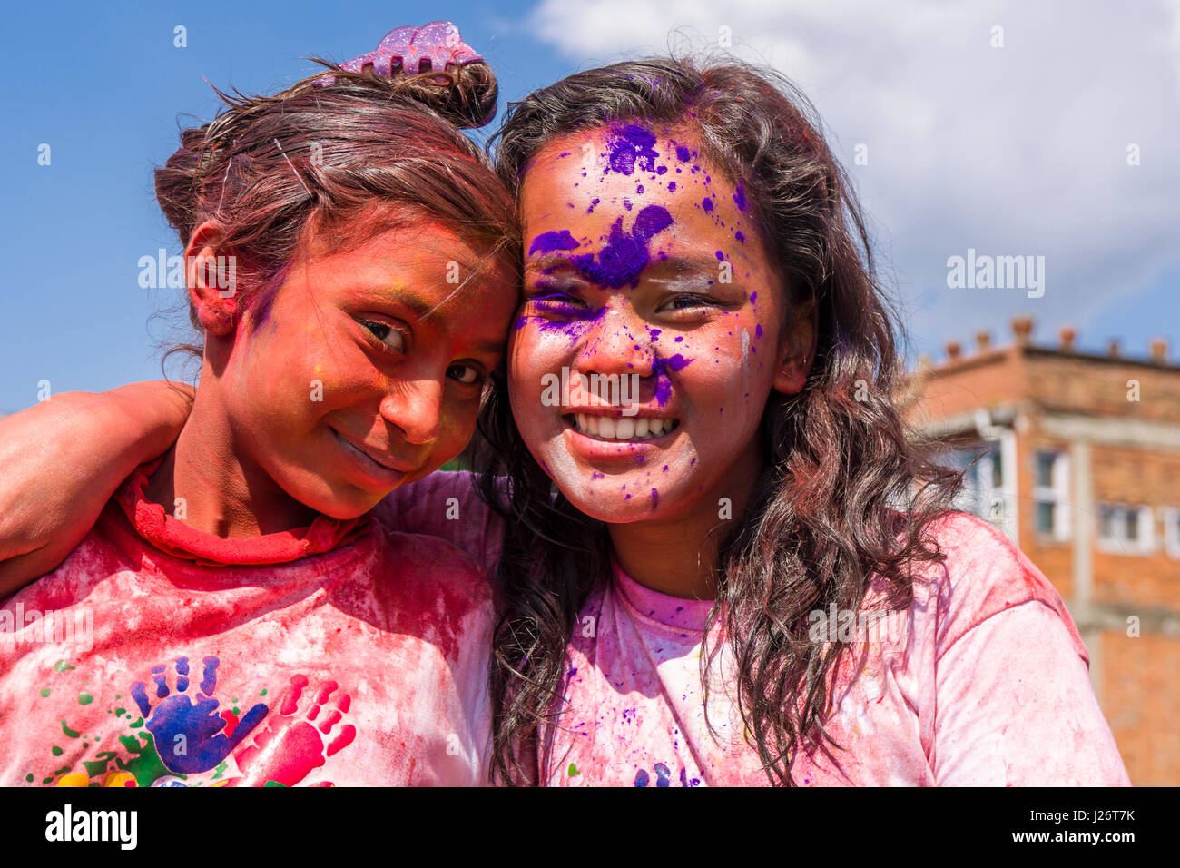 Portraits of young people, smeared with color, are celebrating the Holi Festival Stock Photo