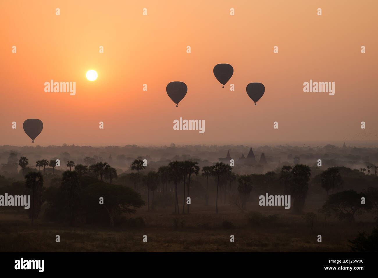 Silhouette of hot-air balloons over plain of Bagan at sunrise in Myanmar (Burma). Stock Photo