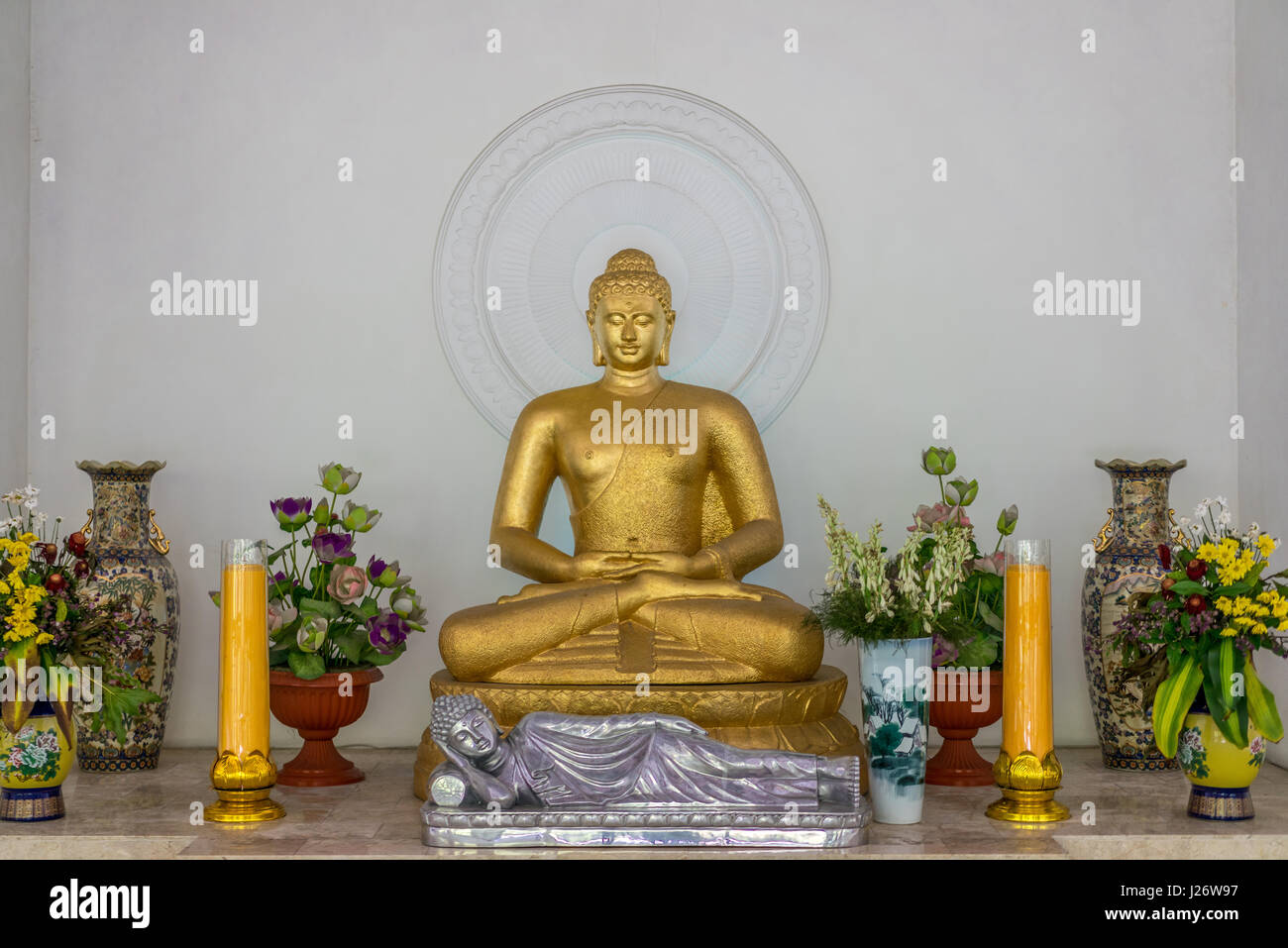 Golden Buddha statues inside meditation hall in Mendut Buddhist